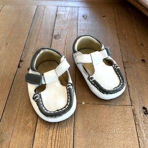 Grey and white leather Petit Pas baby shoes.